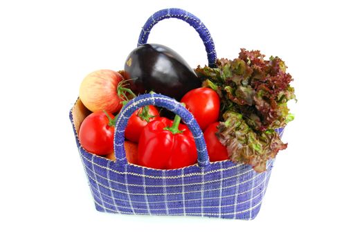 Fresh vegetables and fruits in a basket isolated on white background