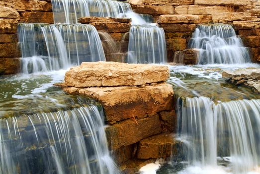 Beautiful cascading waterfall over natural rocks, landscaping element