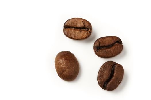 four coffee beans from top on white background