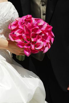 Bride and groom. Closeup on wedding bouquet.
