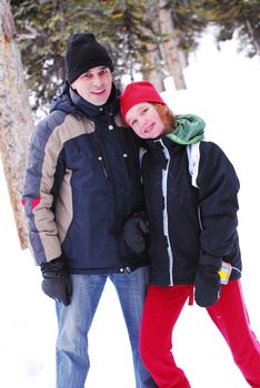 Father and chid playing with snow at winter park