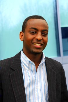 Portrait of a young attractive businessman next to a corporate building