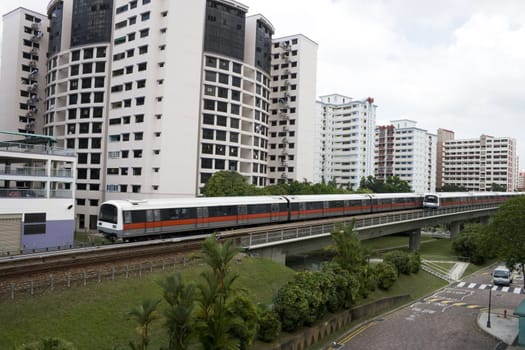 Singapore residential area with train in front.