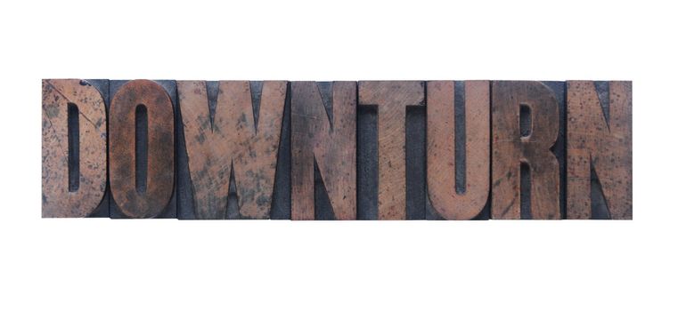 the word 'downturn' in old ink-stained wood type 