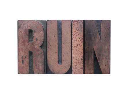 the word 'ruin' in old ink-stained wood type 