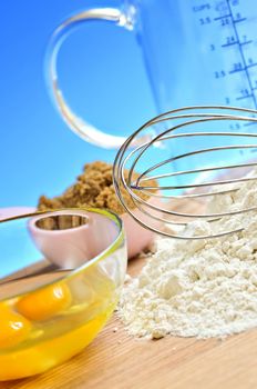 Flour, whisk and eggs in a bowl, baking ingredients