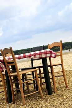 Dining table and chairs set outside on a beach