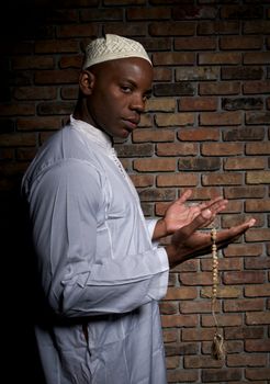 Young african descent muslim prays.