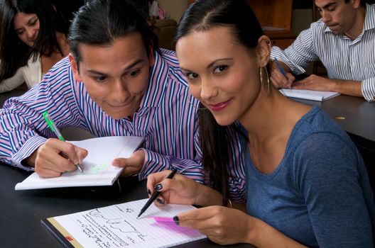 Young adult male trying to copy notes from a coworker during a training session.