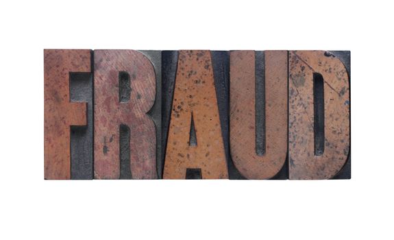 the word 'fraud' in old ink-stained wood type 