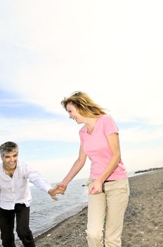 Mature romantic couple walking on a beach