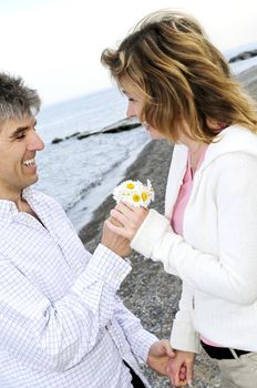 Mature couple enjoying a romantic moment with flowers