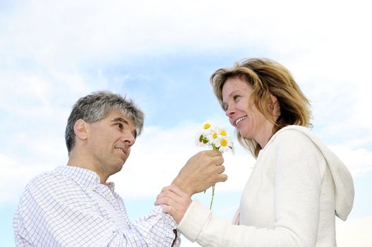 Mature couple enjoying a romantic moment with flowers