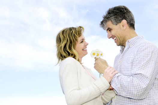 Mature couple enjoying a romantic moment with flowers