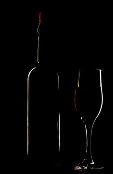 light silhouette of bottle and wineglass