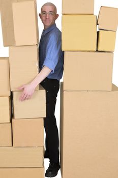 Man clamping between walls from cardboard boxes