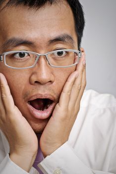 Mature business man with excitation and open mouth, closeup portrait of Asian.