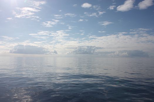 Calm scenery with clouds over the ocean horizon