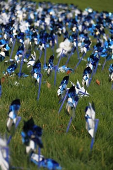 A field full of blue pinwheels spinning in the breeze