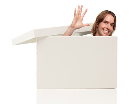 Young Man Waving His Hand and Popping His Head from a Blank White Box Isolated on a White Background - Box Ready for Your Own Message.