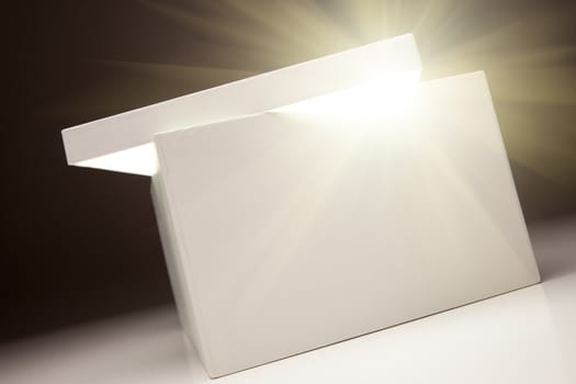 White Box with Lid Revealing Something Very Bright on a Grey Background.