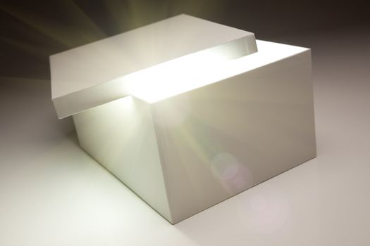 White Box with Lid Revealing Something Very Bright on a Grey Background.