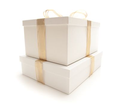 Stacked White Gift Boxes with Gold Ribbon and Bow Isolated on a White Background.