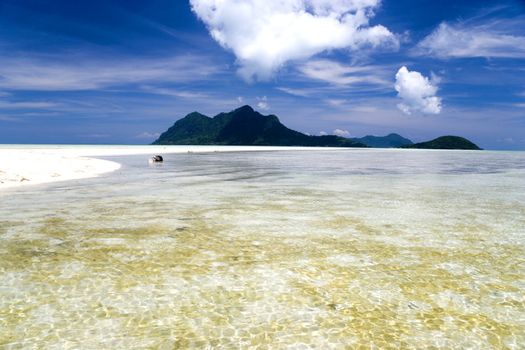 Image of remote Malaysian tropical islands with deep blue skies and crystal clear waters.