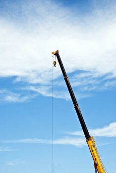 solated yellow  mobile crane with boom up