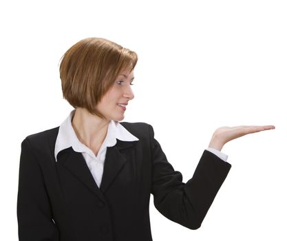 Young businesswoman holding out her hand as if she were displaying something.You can add any text or object on the palm of her hand.