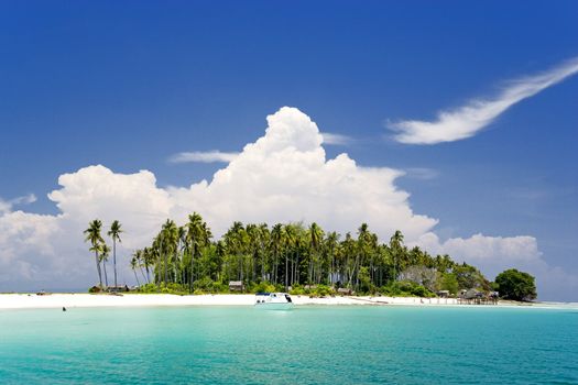 Image of a remote Malaysian tropical island with deep blue skies and crystal clear waters.