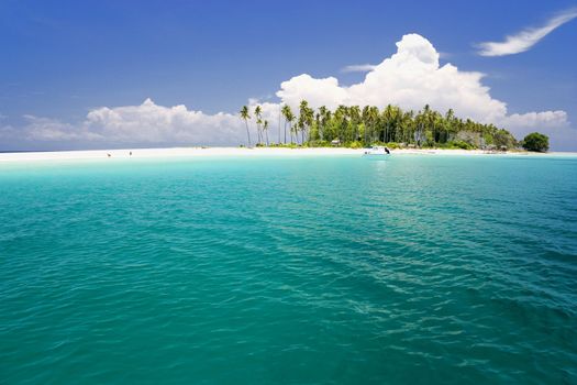 Image of a remote Malaysian tropical island with deep blue skies and crystal clear waters.