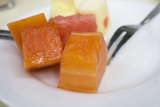 Cut fruits on a plate.