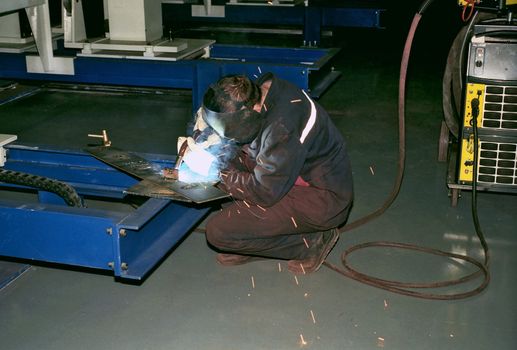 Welder at work on the factory shop floor