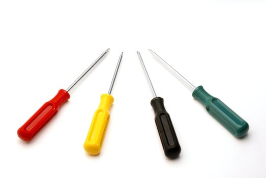 Four colored screwdrivers are isoloated over white.