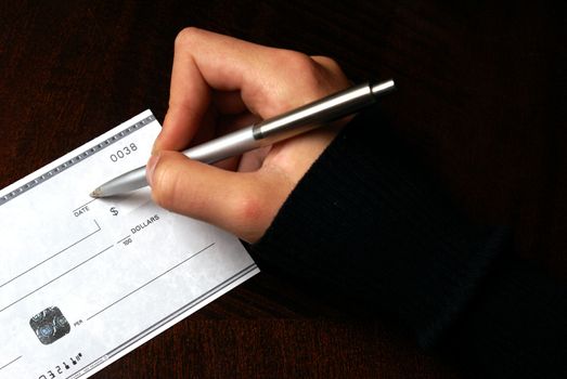 A macro of someone writing a cheque.