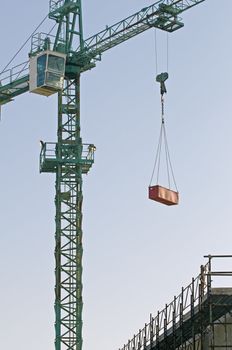 Crane lifting meterial in a construction site