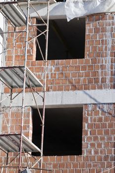 Detail of two windows in a new buinding with scaffonding