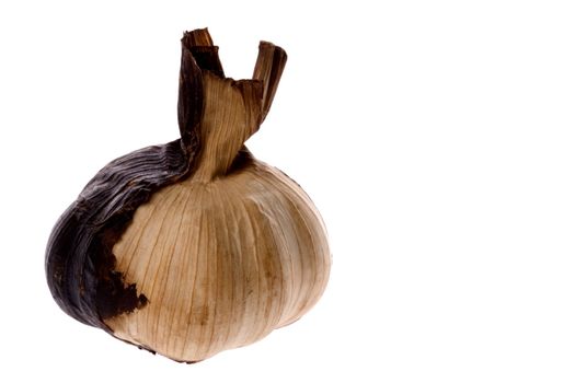 Isolated macro image of a smoked garlic.