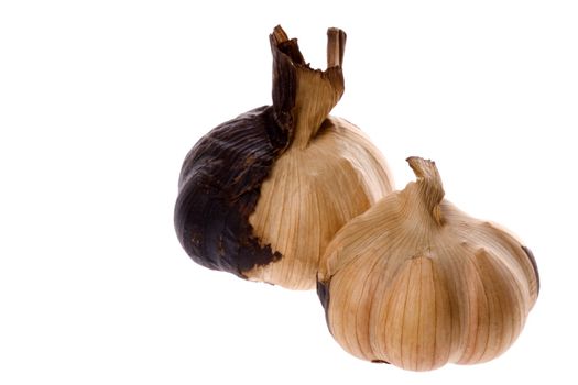 Isolated macro image of smoked garlic.