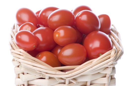 Isolated image of cherry tomatoes in a basket.