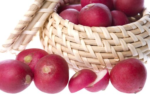 Isolated image of red radish in and around a basket.