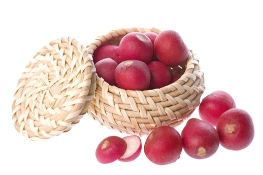 Isolated image of red radish in and around a basket.