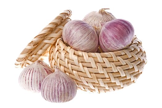 Isolated image of fragrant garlic in and around a basket.