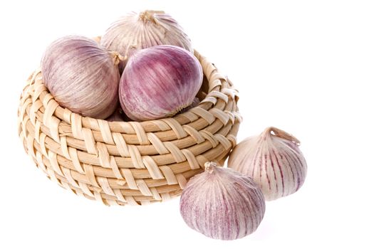 Isolated image of fragrant garlic in and around a basket.