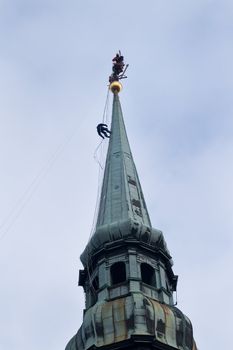 Many Industrial alpinists working at church tower