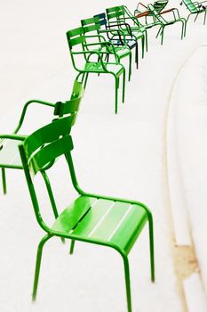 Parisian metallic chairs in the city park. Photo with tilt-shift lens