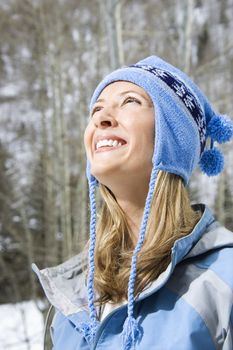 Head and shoulder view of attractive smiling mid adult Caucasian blond woman wearing blue ski clothing.