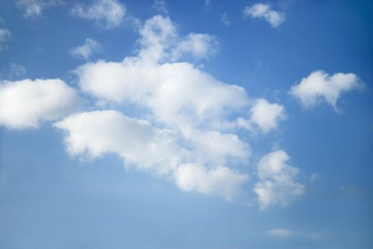 Cumulus clouds in blue sky.