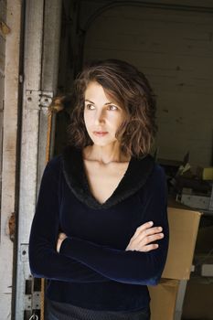 Portrait of pretty Caucasian woman standing with arms crossed.